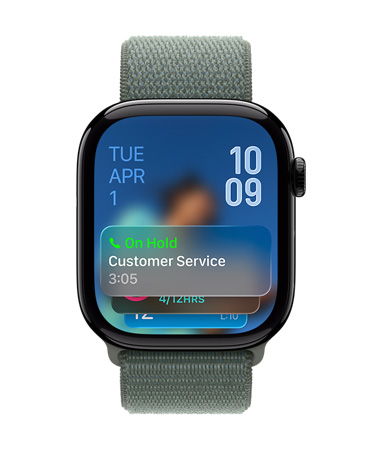 Apple Watch in Jet Black with Sage Band, Face shows Hold assist notification at bottom, date on top left, time numerals stacked at top right