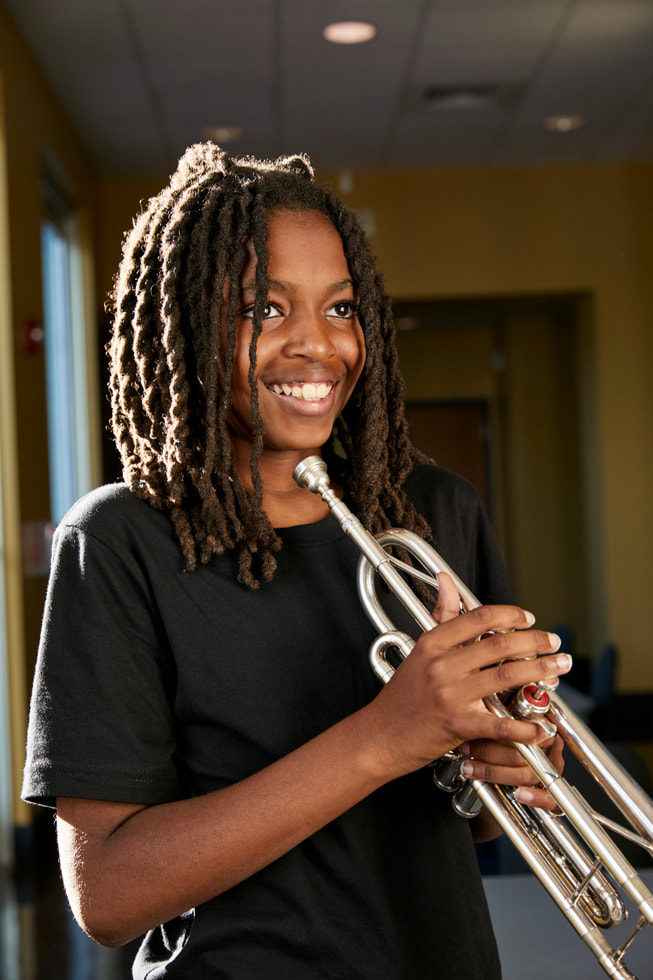 Donte Allen, alumno del Ellis Marsalis Center, toca la trompeta fuera del centro.