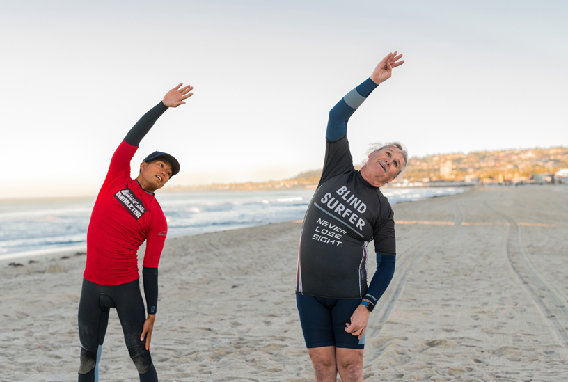 Scott Leason et Gary Lau participent à une session de yoga sur la plage.