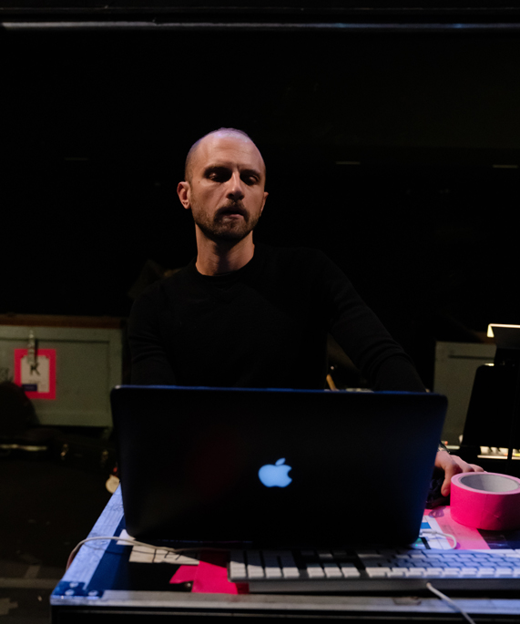 Enrico de Trizio debout derrière un MacBook Pro. 