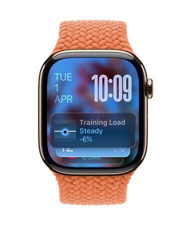 Apple Watch in Rose Gold with a braided strap in Tangerine, face shows date at top left, time with stacked numerals at top right, Training Load widget at bottom, all in translucent Liquid Glass